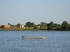 boat passing village, Niger River, Mali