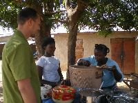 Natitingou, Benin, street scene, buying lunch