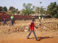 Natitingou, Benin, street scene, bicyclists and walkers