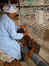 Woman weaving carpet, weaving coop, Ain Draham