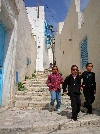 Hip young girls descending one of the "streets" of El Kef