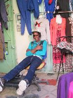 Relaxed shop keeper, er Rich, Morocco