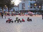 Kids ride toy vehicles as parents look on, Kenitra, Morocco