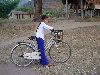 Girl coming from school on bicycle, Pleibroum